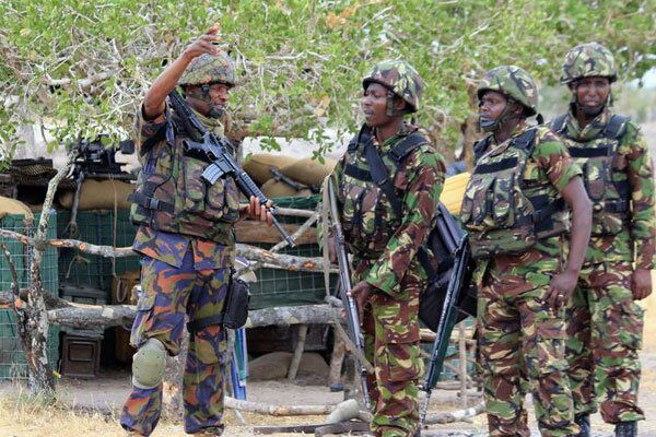 Kenya Defence Forces soldiers converse at their camp in Somalia on February 11, 2017