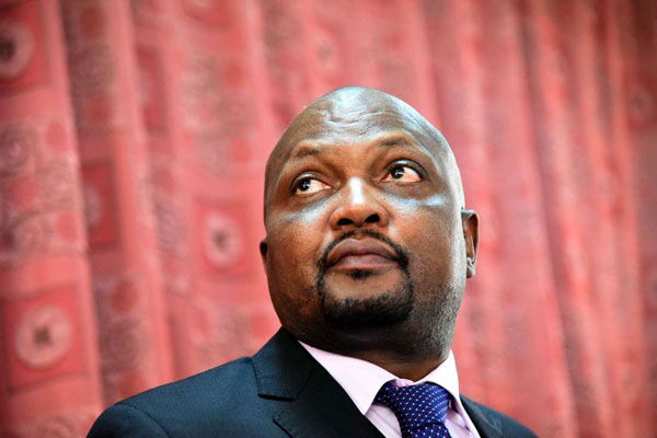 Moses Kuria addresses journalists outside Parliament buildings in 2019. On Friday, January 10, he was arrested and charged with assault