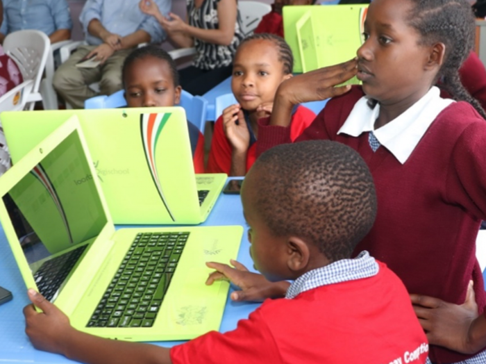 Primary school students using laptops given to them by the government as part of the 2013 pledge.