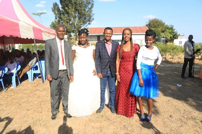Machakos Governor Alfred Mutua (3rd from left )and his wife Lilian (Maroon dress) at his cousin's wedding. The two enjoyed some intimate moments during the ceremony