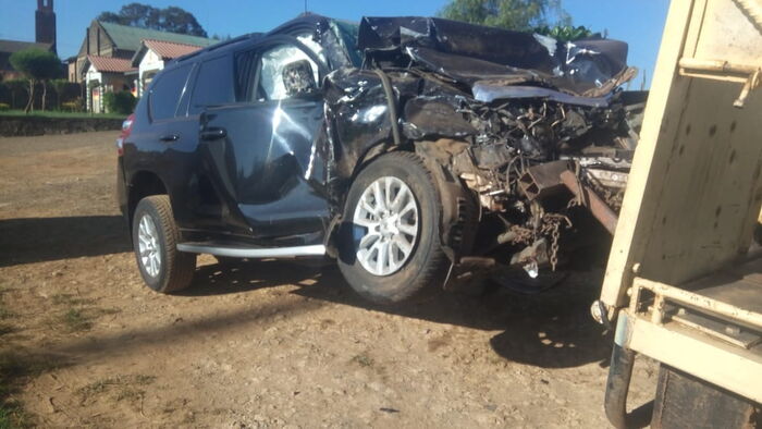 The wreckage of Tuju's car being towed from the accident scene