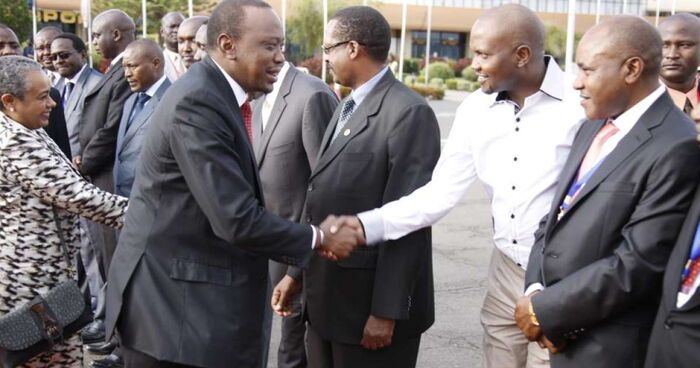 President Uhuru Kenyatta shakes hands with Gatundu South Member of Parliament Moses Kuria.
