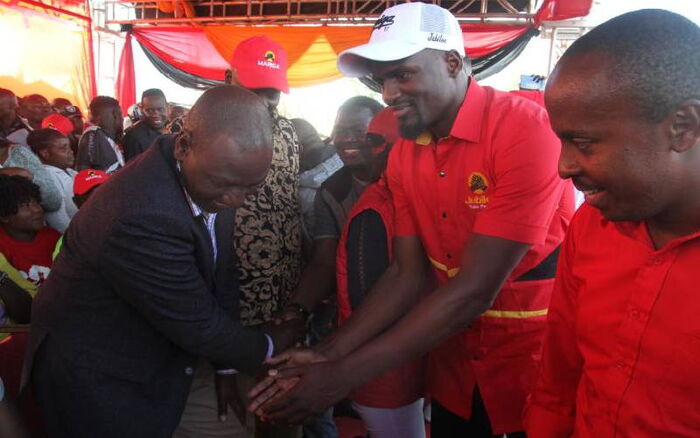 Deputy President William Ruto with Jubilee candidate for Kibra by-election McDonald Mariga in Kibera on October 27.