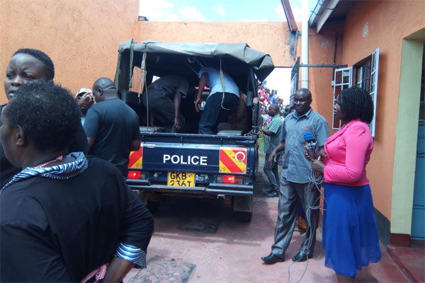 Police take away the body of a man who was allegedly stabbed and killed by his wife in Nakuru's Gorofa Estate on December 12, 2019.