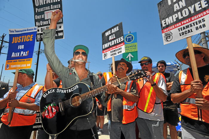 Rage Against the Machine guitarist Tom Morello gave his support to striking truck drivers by singing protest songs in front of the Evergreen terminal on Terminal Island, CA, on Wednesday, July 9, 2014.