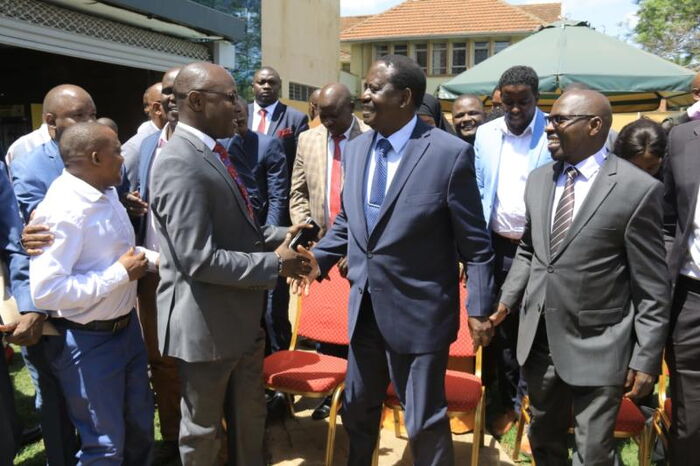 ODM leader Raila Odinga congratulates MCAs David Mberia (right) and Peter Imwatok at a Nairobi hotel in November 2019