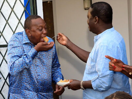 Raila Odinga shares a piece of cake with President Uhuru Kenyatta in Mombasa on January during Raila's birthday on January 7, 2019. The two are now partners under the Building Bridges Initiative