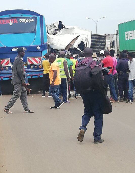 Residents walk past the scene of an accident involving a Kenya Mpya bus and a lorry