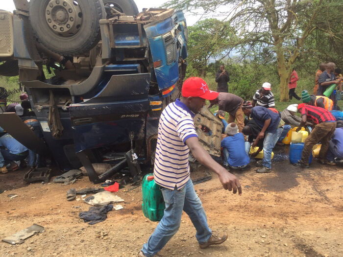 Residents siphoning fuel after a truck overturned along Mai Mahiu road, October 17, 2019.