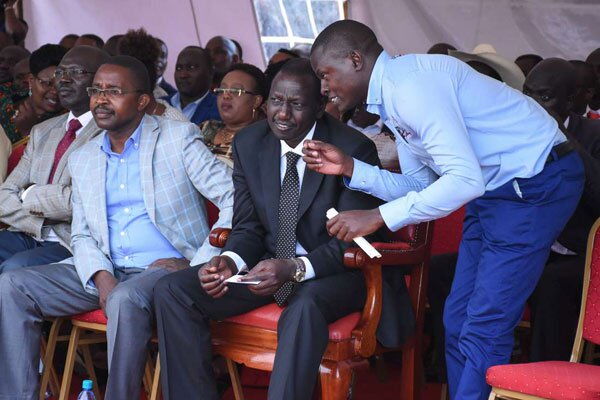 Kiharu MP Ndindi Nyoro (standing) with DP Ruto in a past event. Nyoro grew from being a cobbler to DP Ruto's key ally
