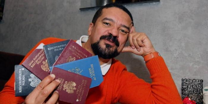 Slawek Muturi with some of his passports during an interview.