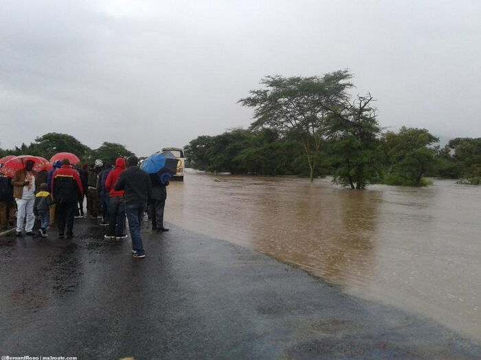 Police Officer Directing Traffic on Flooded Mombasa Road Catches