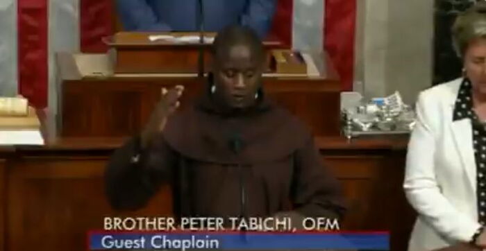 Teacher Peter Tabichi saying a prayer in the US Congress before the sitting began.