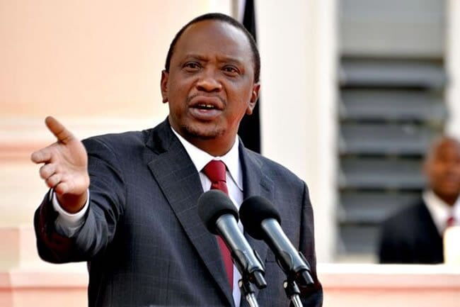 President Uhuru Kenyatta gestures while delivering a past address
