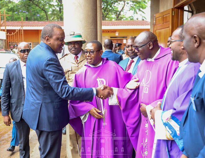 President Uhuru Kenyatta being introduced to members of the clergy by Father Paul Sila at the St. Francis of Asiss Parish Church in Kiambu on Sunday, December 8.