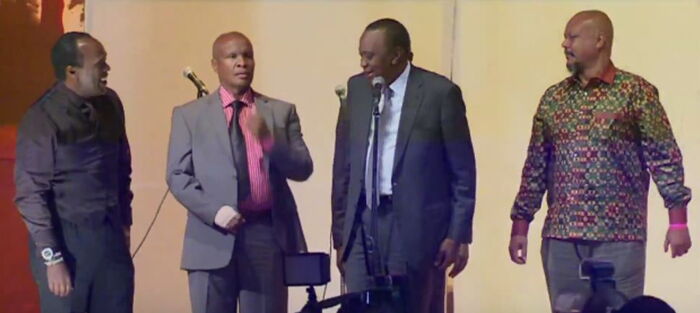 News anchor Jeff Koinange (Left) and President Uhuru Kenyatta (2nd Right) lead St Marys School alumni in singing their alma mater's anthem during the 75th anniversary of the institution.