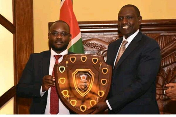 DP Ruto being feted with East by the founder of the award Paul Bamutaze on Tuesday..