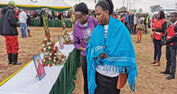 Parents view photos of pupils who perished in the Precious Talent School tragedy.