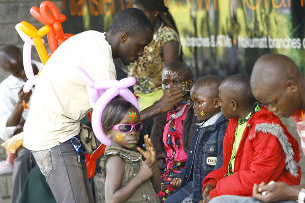 Children line up to have their faces painted at the Uhuru recreational gardens in Nairobi.