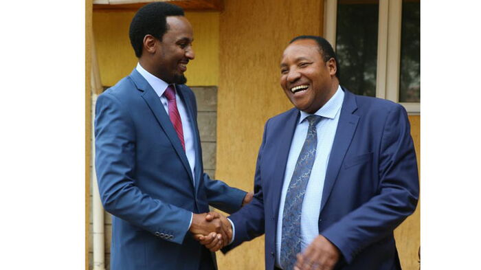 Embattled Kiambu Governor Ferdinand Waititu (right) congratulates Karungo wa Thang'wa for taking over as Youth Affairs, Sports and Communication executive in July 2018.