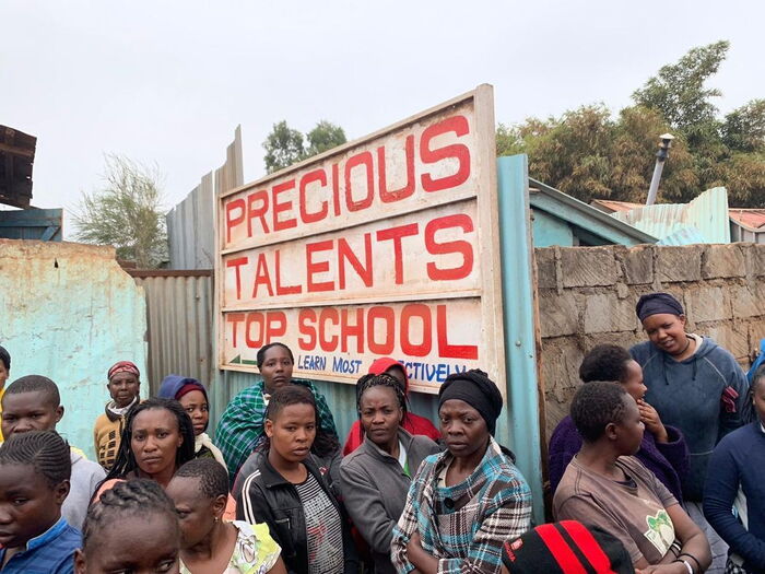 Parents outside the Precious Talent Primary School. The directive to asses and shut down unsafe schools was given after a classroom collapsed taking the lives of seven pupils of the institutions.