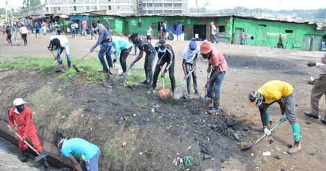 Youth partake in a clean-up exercise as part of the Kazi Mtaani program.