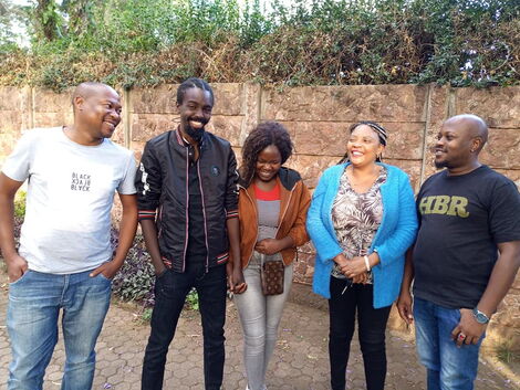 Former TPF contestant David Major (second left) holds his sister's hand after they were reunited after 5 years