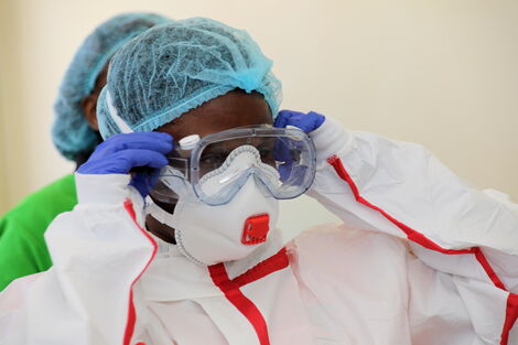 A medical practitioner dresses in protective gear at Coronavirus isolation and treatment facility in Mbagathi District Hospital on Friday, March 6, 2020.