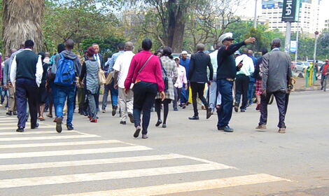 Stock image of Kenyans crossing a street in Nairobi.