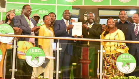 William Ruto on the left holds his certificate with Rigathi Gachagua on the right accompanied by other Kenyan Kwanza leaders at Bomas of Kenya on August 15, 2022