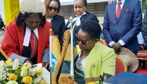 Meru Governor Kawira Mwangaza signing official documents after being sworn in as Meru Governor at Kinoru Stadium on August 25, 2022