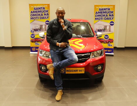 Zadock Sanawa posing with his new car on December 2, 2021.