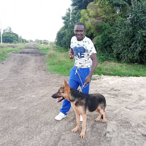 Boxer Nick Okoth with his security dog.