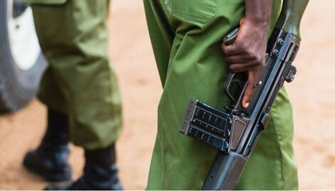 A Kenyan police officer holding a gun 