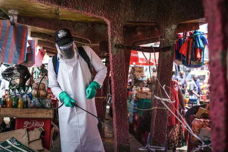 An official from the Ministry of Health disinfects a section of Gikomba market in Nairobi on March 22, 2020.