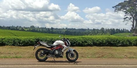 A picture of a motorcycle by the road