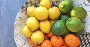 A bowl of different citrus fruits