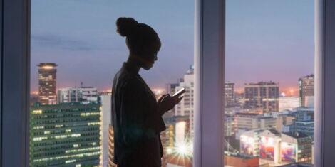 A businesswoman checking messages on a smart phone