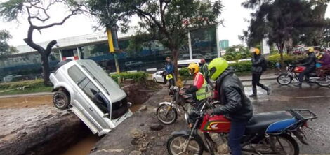 A car inside a ditch along Uhuru Highway at Nyayo Roundabout.
