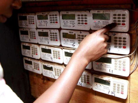 A customer keys in tokens in a prepaid electric meter