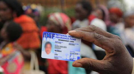 A hand holding a National Hospital Insurance Fund card