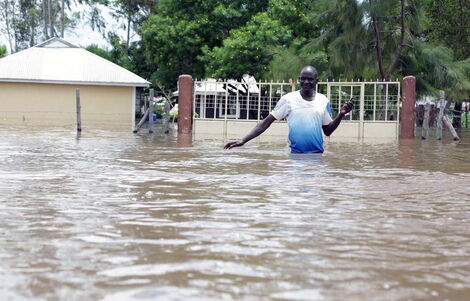 A man submerged halfway in floodwaters in Nyando on Tuesday, April 21, 2020.