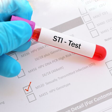 A medic holding an STI test kit