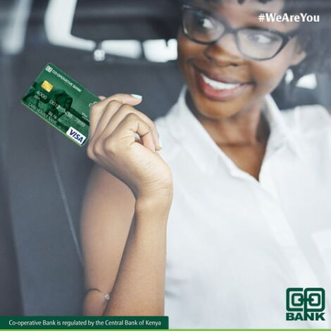 A person holding a Co-op Bank Kenya card