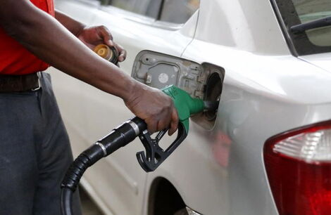 An undated image of a petrol station attendant pumping fuel into a car.