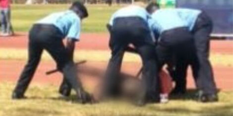 A photo of the football fan pinned down by four police officers at Kasarani stadium on February 15, 2023.jpg