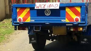 A pickup truck displaying the 'Wide Load' signage.
