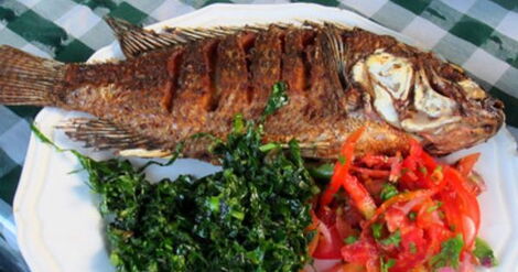 A plate of fish and green vegetables