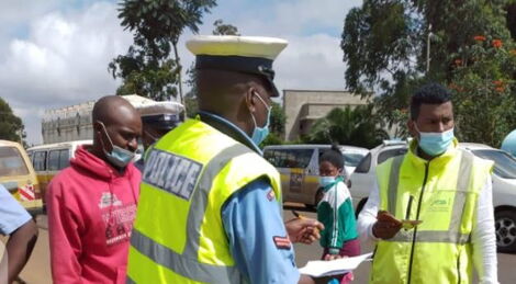 A police officer engages a motorist during the NTSA crackdown on Tuesday, May 4, 2021.