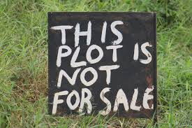 A sign post showing that the land is not for sale